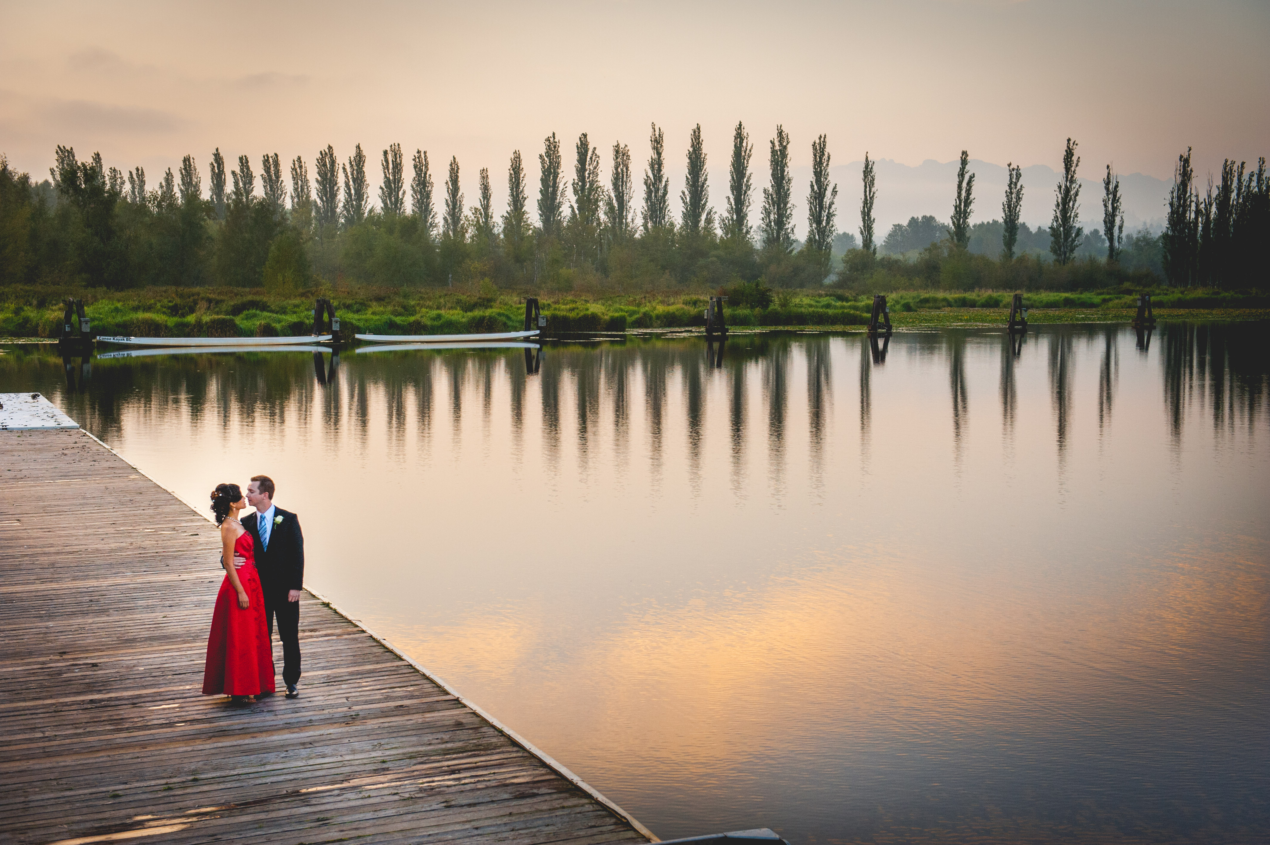 A couple is about to kiss beside the lake 