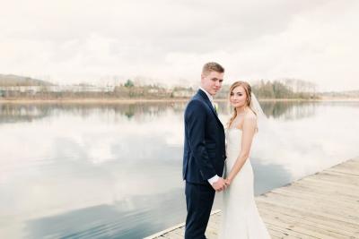Newly weds posing by the lake