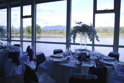 Room set up for event. View of lake through windows