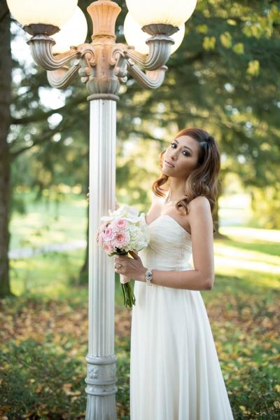 Bride posing by a lamp post.