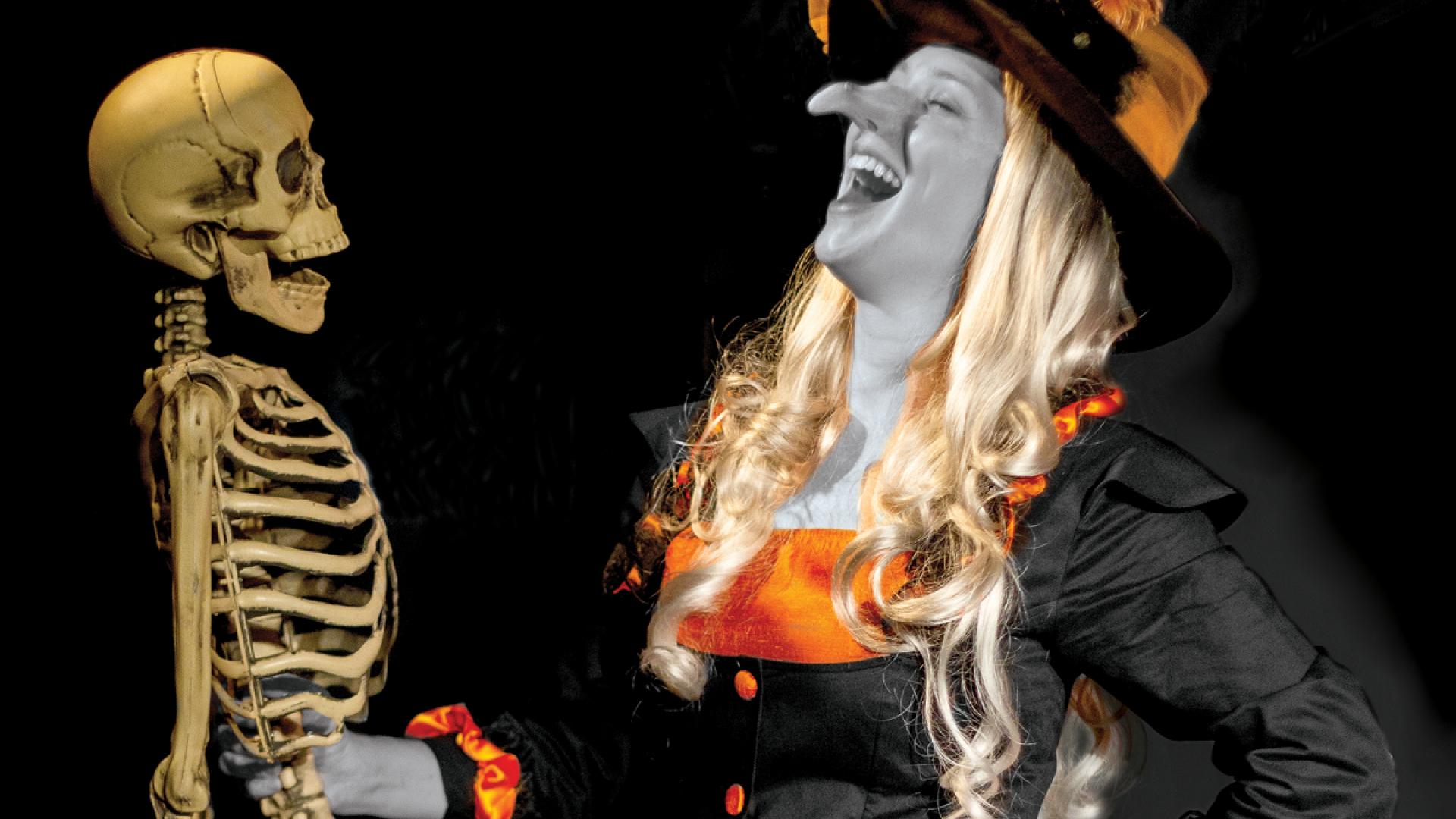 Fun witch laughing with skeleton